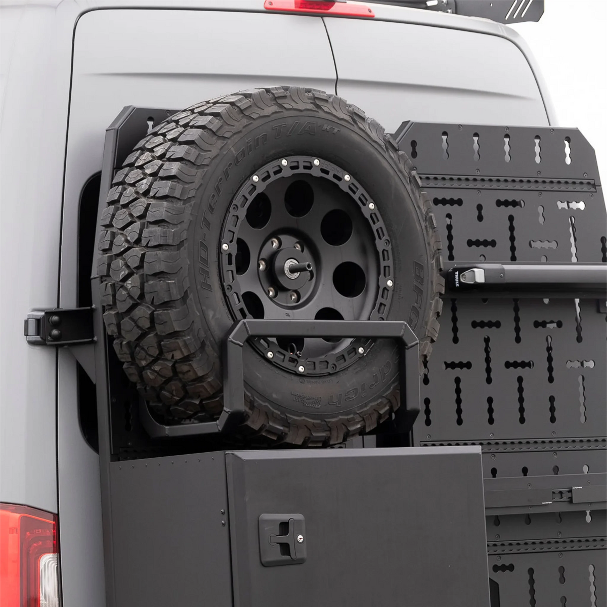 XBull spare wheel carrier holding an off-road tire on a Sprinter rear rack, view 11