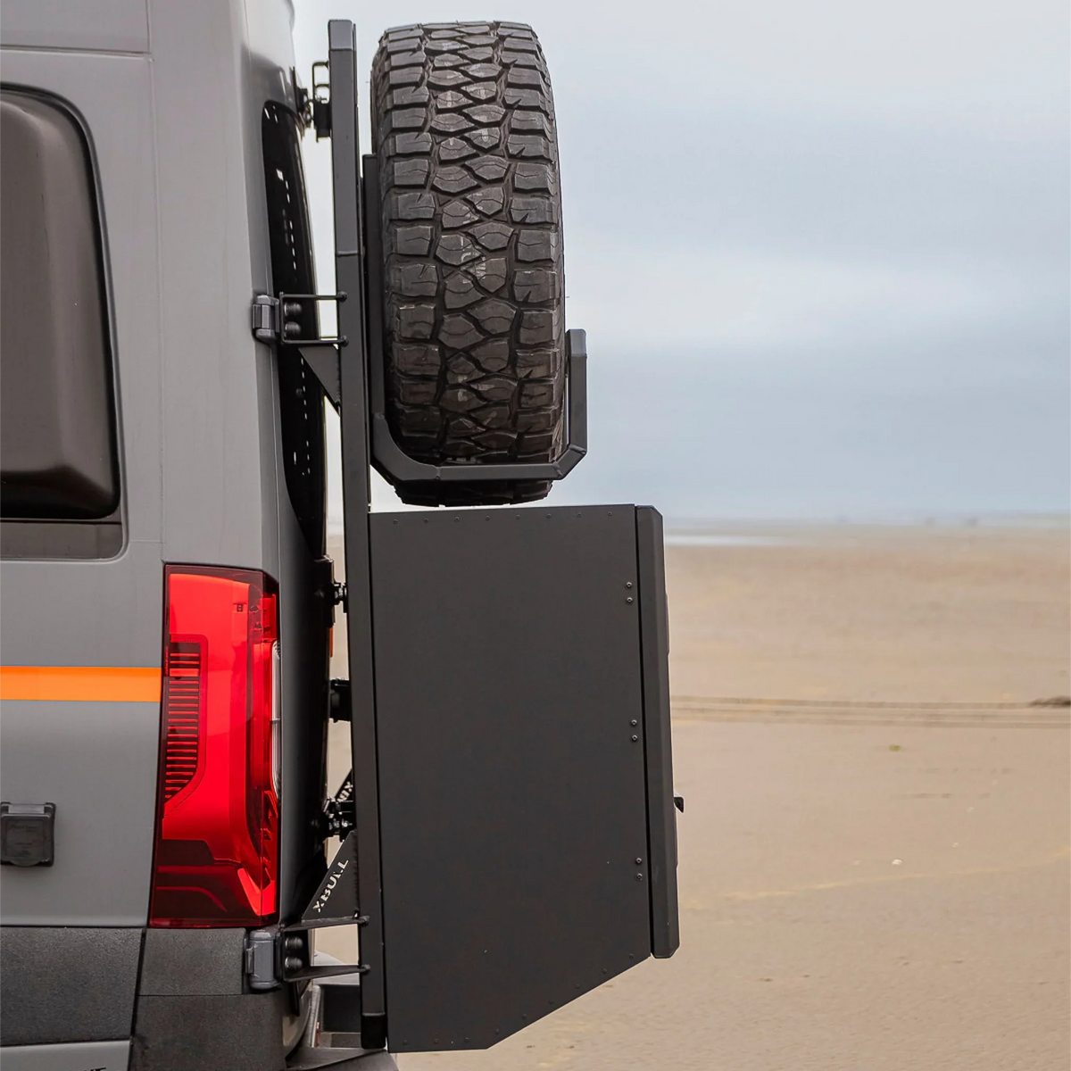 XBull spare wheel carrier holding an off-road tire on a Sprinter rear rack, view 5